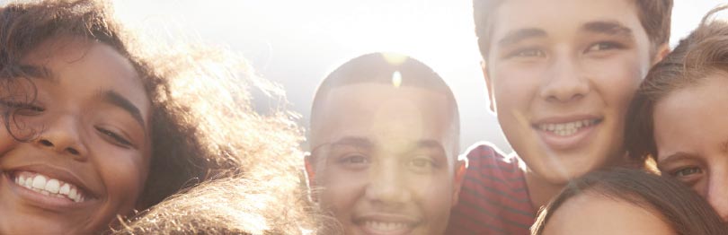 Group of teens smiling at a camera