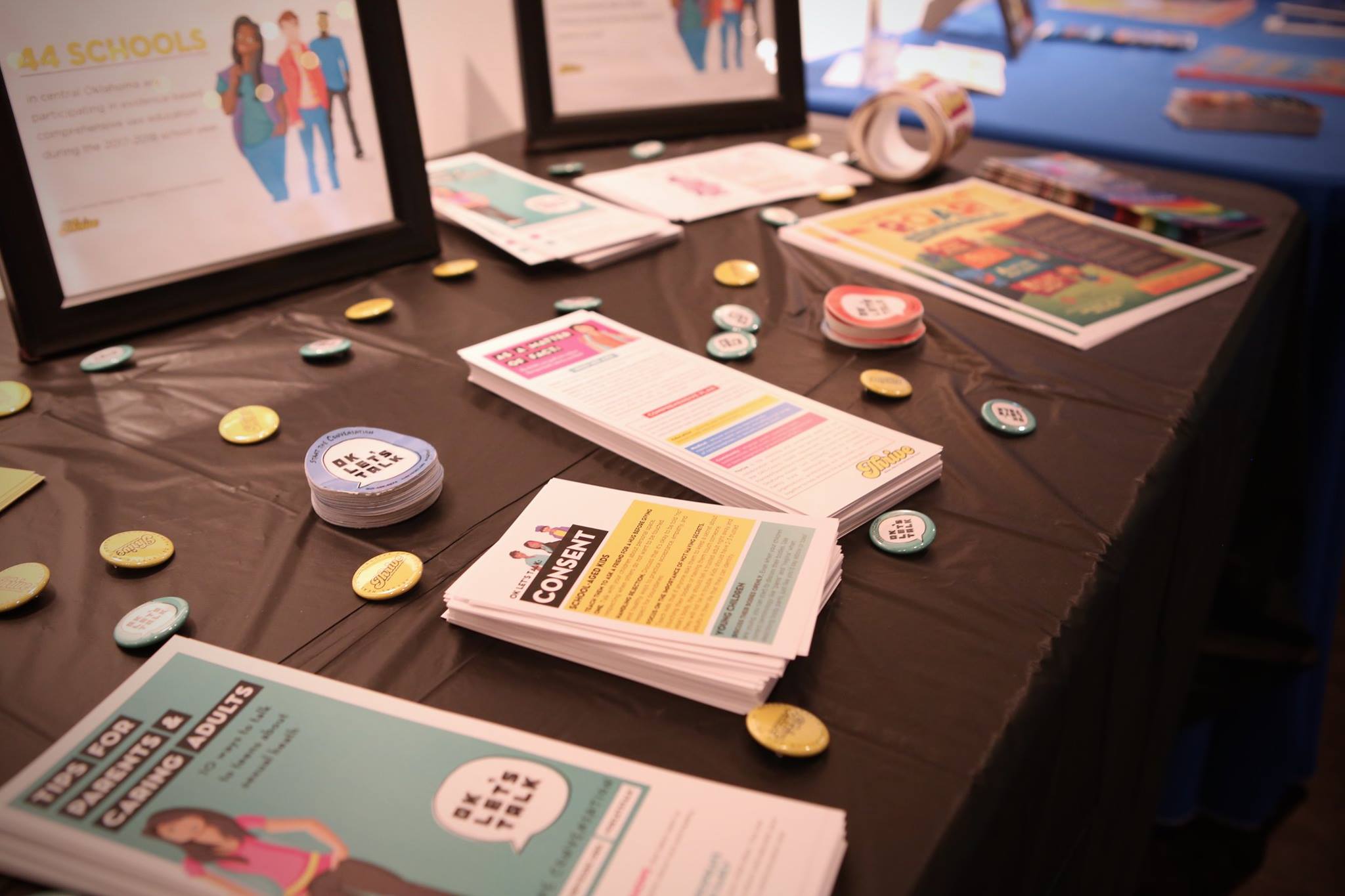 Photo of various materials from the Collaboration, including pamphlets, stickers, and buttons.