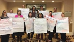 Teachers holding banners with written ideas
